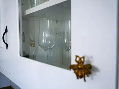 a group of wine glasses sitting on a shelf at Victorian quirky farm cottage next to forest & close to beach in Woodbridge