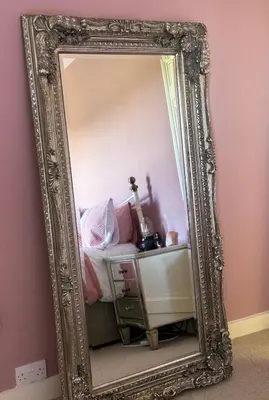 an ornate mirror in a girls bedroom with pink walls at Victorian quirky farm cottage next to forest & close to beach in Woodbridge