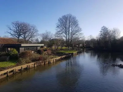 a river with ducks swimming in the water at Landscape, New Eco Lodge Flatford Mill in East Bergholt