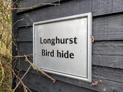 a sign on a building that reads longest bird hide at Landscape, New Eco Lodge Flatford Mill in East Bergholt