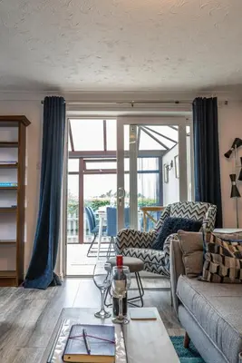 a living room with a couch and a table at 2 Bedroom Rural Escape In Peaceful Elmswell in Woolpit