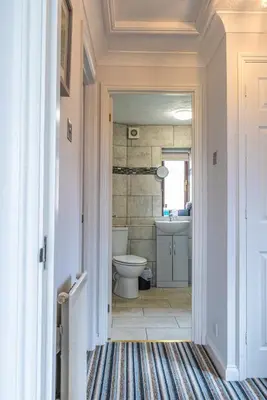 a bathroom with a toilet and a sink at 2 Bedroom Rural Escape In Peaceful Elmswell in Woolpit