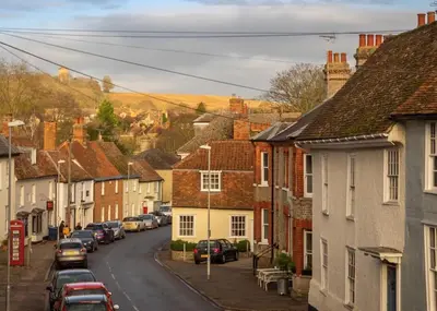 a street in a small town with houses at The Old Reading Rooms Linton in Linton
