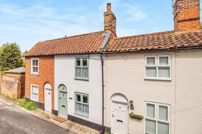 a row of houses on the side of a street at Curlew Cottage Woodbridge Suffolk Cosy Victorian cottage for couple and dog in Woodbridge