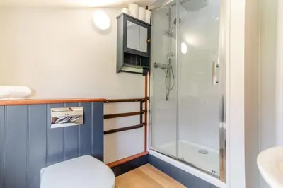 a bathroom with a shower and a toilet and a sink at Curlew Cottage Woodbridge Suffolk Cosy Victorian cottage for couple and dog in Woodbridge
