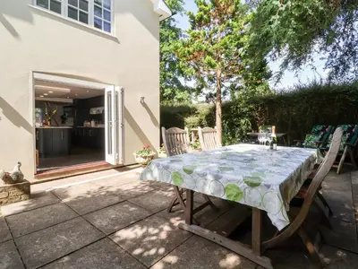 a table and chairs sitting on a patio at Cavan Cottage in Saxmundham