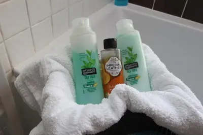 two bottles of cleaning products sitting on a towel at The Zen Den in Southend-on-Sea