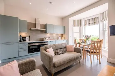 a living room with a couch and a table at Trehafod, Aldeburgh in Aldeburgh