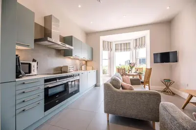 a kitchen with two chairs and a table in it at Trehafod, Aldeburgh in Aldeburgh