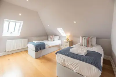 a bedroom with two beds and a window at Swn-y-Don, Aldeburgh in Aldeburgh