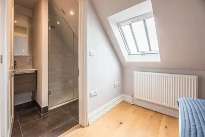 a bathroom with a walk in shower and a window at Swn-y-Don, Aldeburgh in Aldeburgh