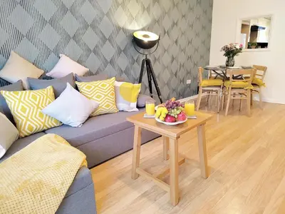 a living room with a couch and a table with fruit on it at 2 Single Beds, 1 BR Apartment in Newmarket