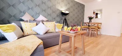 a living room with a couch and a table at 2 Single Beds, 1 BR Apartment in Newmarket