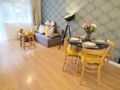 a living room with a table and a couch at 2 Single Beds, 1 BR Apartment in Newmarket