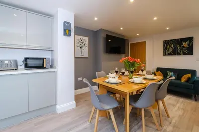 a kitchen and dining room with a table and chairs at Primrose Cottage, Leiston, near Sizewell, Thorpeness and Aldeburgh - Managed by Aldeburgh Coastal Cottages in Leiston