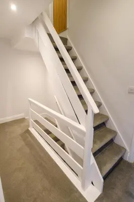 a white stair case in a house at Primrose Cottage, Leiston, near Sizewell, Thorpeness and Aldeburgh - Managed by Aldeburgh Coastal Cottages in Leiston