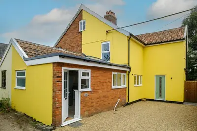 a yellow house with a brick at Primrose Cottage, Leiston, near Sizewell, Thorpeness and Aldeburgh - Managed by Aldeburgh Coastal Cottages in Leiston
