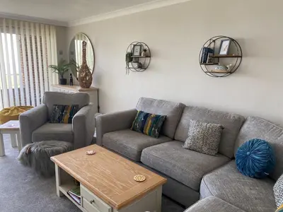 a living room with a couch and two chairs at La de da Frinton on Sea in Frinton-on-Sea