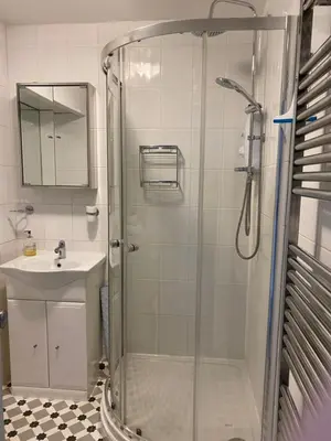 a bathroom with a shower and a sink at La de da Frinton on Sea in Frinton-on-Sea