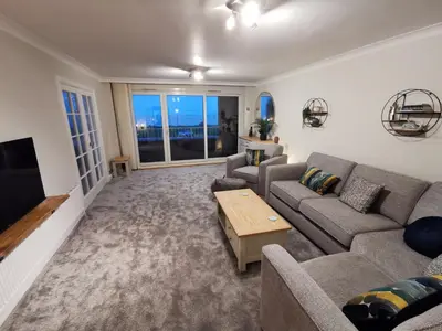 a living room with a couch and a tv at La de da Frinton on Sea in Frinton-on-Sea