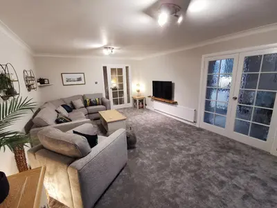 a living room with a couch and a tv at La de da Frinton on Sea in Frinton-on-Sea