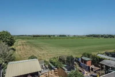 an aerial view of a field and a farm at Number 27, Alderton in Woodbridge