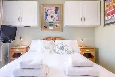 a bedroom with a white bed with two towels on it at Number 27, Alderton in Woodbridge