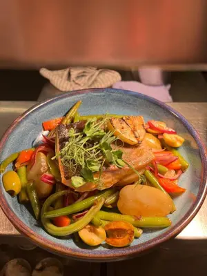 a blue bowl of food with meat and vegetables at The Crown Pub and Hotel in Manningtree
