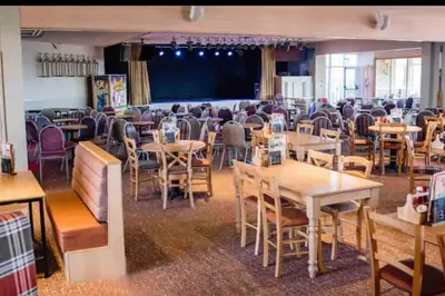 a dining room filled with tables and chairs at Rohannah Luxe Coastal Escape, Cooper Beach East Mersea in East Mersea