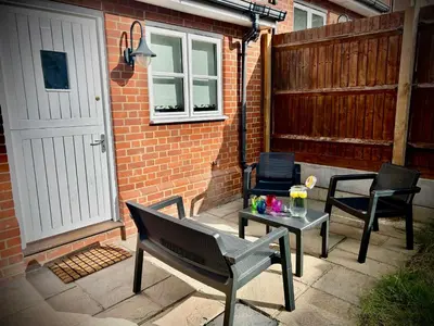 a patio with chairs and a table with drinks on it at 5 Bedroom House - DISC0UNTS - Parking, Contractors, Group, Family in Braintree