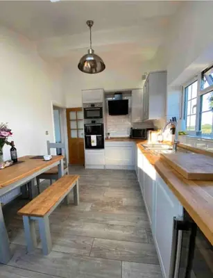 a large kitchen with wooden counters and a wooden bench at Near Woodbridge The Annexe Eyke Fantastic views with Dog secure Garden and Paddock in Eyke