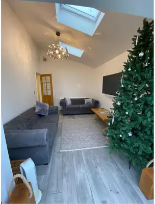 a living room with a christmas tree and a couch at Near Woodbridge The Annexe Eyke Fantastic views with Dog secure Garden and Paddock in Eyke