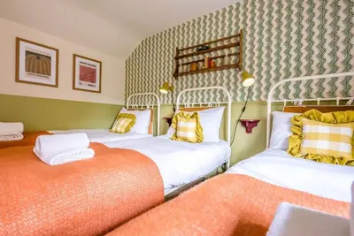 two beds in a room with two at The Old Forge, Great Glemham in Great Glemham