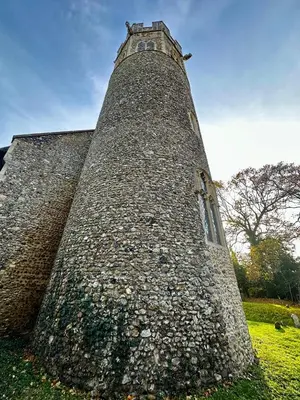 a large stone building with a clock tower at Chez Ana in Saxmundham