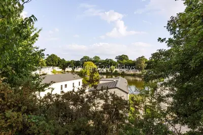 a view of the river from the trees at Stunning Lodge With Decking At Oaklands Holiday Park In Essex Ref 39017Rw in Clacton-on-Sea