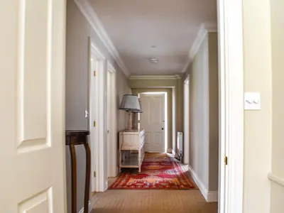 an empty hallway with a lamp and a rug at An Croke in Higham