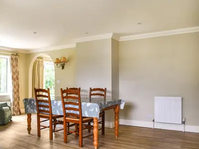 a dining room with a table and chairs at An Croke in Higham