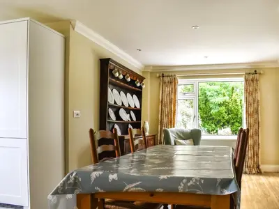 a dining room with a table and chairs at An Croke in Higham