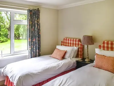 two beds in a room with a window at An Croke in Higham