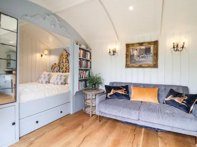 a living room with a couch and a book shelf at Utopia in Harleston