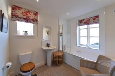 a bathroom with a toilet and a sink and a tub at Butley Priory Farmhouse 12 in Woodbridge