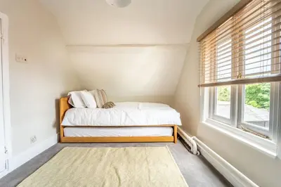 a small bedroom with a bed and a window at 5 Bed Farmhouse Suitable for Contractors Private Parking in Potter Street