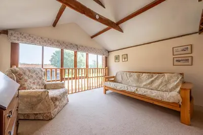 a living room with a couch and a chair at The Old Barn in Semer