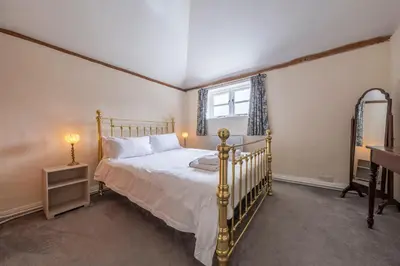 a bedroom with a bed and a window at The Old Barn in Semer