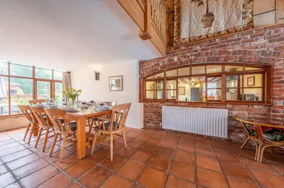 a dining room with a table and chairs at The Old Barn in Semer