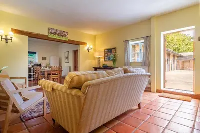 a living room with a couch and a table at Semer Barn in Semer
