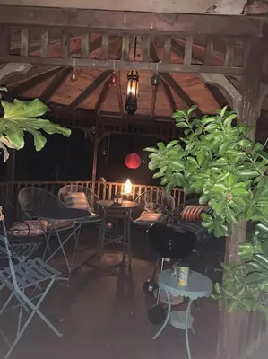 a room with chairs and a table with a candle at Attractive 2 storey, 2 bedroom barn in Long Melford in Long Melford