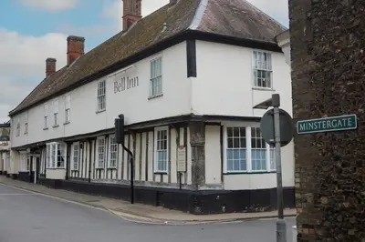 an old white building on the corner of a street at Bell by Greene King Inns in Thetford