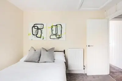 a bedroom with a white bed with two pillows at Nice 2 bedroom house in Stowmarket in Stowmarket