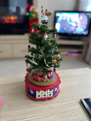 a miniature christmas tree on top of a table at Happy Place in West Mersea